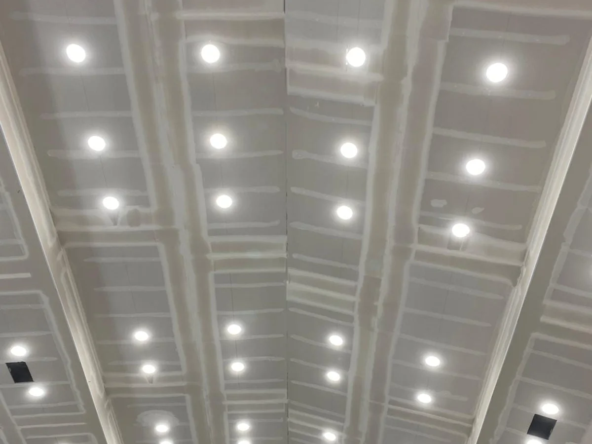 Ceiling hung around a grid of can lights