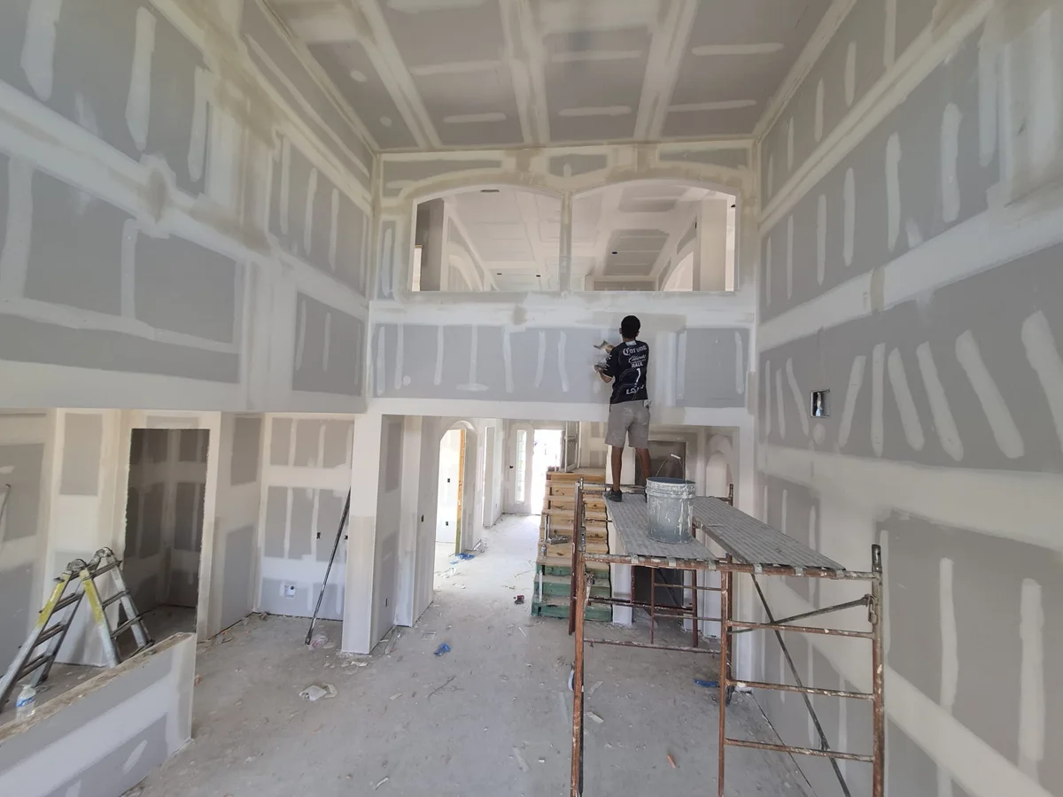 Two-story great room with drywall hung and taped